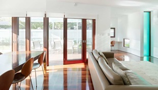 The dynamic roofline creates irregular shaped interiors with quirky features, such as the study/play niche off the living area.